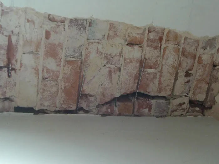 Mortar joints cut out across a crack, ready for HeliBars